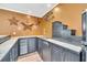 Finished basement features a bar area with sink, storage, and decorative star accents at 214 Kingsley Way, Woodstock, GA 30188
