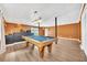 Basement rec room features luxury vinyl flooring, pool table, and bar at 214 Kingsley Way, Woodstock, GA 30188