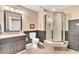 Bathroom features a tiled floor, stand up shower, and black vanity with granite counter tops at 214 Kingsley Way, Woodstock, GA 30188