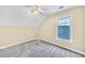 Light-filled bedroom features carpet, and large window with backyard views at 214 Kingsley Way, Woodstock, GA 30188
