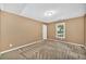 Neutral bedroom features patterned carpet, closet, and natural lighting at 214 Kingsley Way, Woodstock, GA 30188