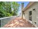 Spacious wooden deck overlooking a lush, green backyard with mature trees at 214 Kingsley Way, Woodstock, GA 30188
