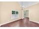 Elegant dining room with hardwood floors, a chandelier, and ample natural light at 214 Kingsley Way, Woodstock, GA 30188