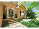 Inviting front porch with brick steps, decorative wreath, and a cozy bench at 214 Kingsley Way, Woodstock, GA 30188