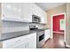 Stylish kitchen featuring stainless steel appliances and granite countertops at 214 Kingsley Way, Woodstock, GA 30188