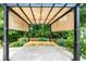Backyard pergola with privacy curtains and greenery at 214 Kingsley Way, Woodstock, GA 30188