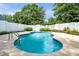 Private in-ground pool surrounded by lush greenery and a white picket fence, perfect for relaxation at 214 Kingsley Way, Woodstock, GA 30188