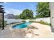 In-ground pool is surrounded by a concrete pool deck and white fencing at 214 Kingsley Way, Woodstock, GA 30188