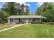Inviting one-story home with a well-maintained lawn and symmetrical landscaping at 3131 Garden Lane Dr, Marietta, GA 30062