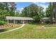Charming single-story home with a manicured lawn and mature trees at 3131 Garden Lane Dr, Marietta, GA 30062