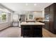 Eat-in kitchen boasts updated stainless appliances, white cabinets, and a center island with seating at 3131 Garden Lane Dr, Marietta, GA 30062