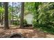 The property features a storage shed with a fire pit surrounded by mature trees and lush greenery at 3131 Garden Lane Dr, Marietta, GA 30062