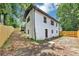 The backyard shows a large, open space surrounded by lush greenery and a wooden fence at 3807 Greenhill Dr, Chamblee, GA 30341