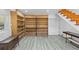 Spacious basement area with built-in shelving, wood-look flooring, and a staircase at 3807 Greenhill Dr, Chamblee, GA 30341