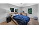 Cozy bedroom with hardwood floors, neutral walls, and a large window with a view of the trees at 3807 Greenhill Dr, Chamblee, GA 30341
