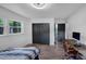 Bedroom with two windows, dark closet, wooden desk, and an ergonomic chair at 3807 Greenhill Dr, Chamblee, GA 30341