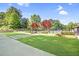 Community space with manicured lawn, walkway, landscaping and wrought iron fence at 3807 Greenhill Dr, Chamblee, GA 30341