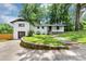 Charming white brick home with lush green lawn and driveway at 3807 Greenhill Dr, Chamblee, GA 30341