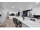Open kitchen with seating at the marble island, stainless appliances, and sleek cabinetry at 3807 Greenhill Dr, Chamblee, GA 30341