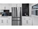 Kitchen with stainless steel refrigerator, black subway tile backsplash, and modern hardware at 3807 Greenhill Dr, Chamblee, GA 30341