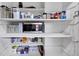 Walk-in pantry with white shelves storing food containers and a microwave at 3807 Greenhill Dr, Chamblee, GA 30341