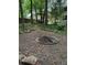 Secluded backyard with firepit, wooded area, and a picnic table, perfect for outdoor entertaining at 515 Rosedown Way, Lawrenceville, GA 30043