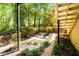 Scenic backyard with lush garden, retaining walls, and staircase to upper level at 515 Rosedown Way, Lawrenceville, GA 30043