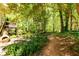 Backyard with walking path and greenery-filled surroundings at 515 Rosedown Way, Lawrenceville, GA 30043