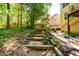 Home's backyard features wood stairs leading to an landscaped yard at 515 Rosedown Way, Lawrenceville, GA 30043