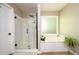Bright bathroom featuring a soaking tub, a walk-in shower, and updated fixtures at 515 Rosedown Way, Lawrenceville, GA 30043