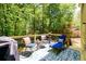 Back deck perfect for relaxation with lounge chairs and natural wooded scenery at 515 Rosedown Way, Lawrenceville, GA 30043