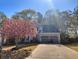 Inviting two-story home with a two-car garage, flowering tree and a well-manicured lawn at 515 Rosedown Way, Lawrenceville, GA 30043