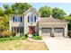 Charming two-story home with a well-maintained front yard, attached two-car garage, and a vibrant red front door at 515 Rosedown Way, Lawrenceville, GA 30043