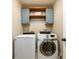 Laundry room featuring updated machines and wood shelves at 515 Rosedown Way, Lawrenceville, GA 30043