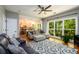 Open-concept living room and kitchen with hardwood floors and large windows offering views of the backyard at 515 Rosedown Way, Lawrenceville, GA 30043