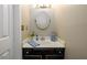 Cozy powder room featuring a stylish mirror, vanity, and light fixture, perfect for guests at 515 Rosedown Way, Lawrenceville, GA 30043