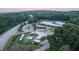 Scenic aerial view featuring a school, playground with covered picnic areas, and surrounding green spaces at 517 Godfrey Dr, Cumming, GA 30040