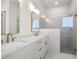Modern bathroom featuring double sinks, granite countertops, and glass-enclosed shower at 517 Godfrey Dr, Cumming, GA 30040