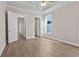Light-filled bedroom with wood-look floors and double doors to the ensuite bathroom at 517 Godfrey Dr, Cumming, GA 30040
