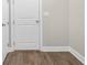Bedroom features wood flooring, white walls, and a door to a closet at 517 Godfrey Dr, Cumming, GA 30040
