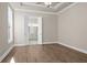 Bright bedroom featuring wood-look floors, and double doors to the ensuite bathroom at 517 Godfrey Dr, Cumming, GA 30040