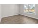 Bedroom featuring wood flooring and a large window overlooking the front yard at 517 Godfrey Dr, Cumming, GA 30040