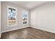 Bedroom with wood-look floors and two large windows with outside views at 517 Godfrey Dr, Cumming, GA 30040