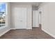 Bedroom featuring wood flooring, large window, and closet space at 517 Godfrey Dr, Cumming, GA 30040