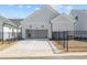 Garage with a long driveway and black fences at 517 Godfrey Dr, Cumming, GA 30040