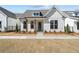 Charming single-story home featuring a board and batten siding and a welcoming entry with a blue door at 517 Godfrey Dr, Cumming, GA 30040