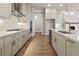 Modern kitchen featuring a gas range, stainless appliances, and a center island with a sink at 517 Godfrey Dr, Cumming, GA 30040