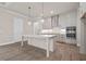 Bright kitchen with stainless steel appliances, a large center island with quartz countertops at 517 Godfrey Dr, Cumming, GA 30040
