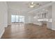 Open concept living area featuring wood floors and sliding glass doors with an open view of the kitchen at 517 Godfrey Dr, Cumming, GA 30040