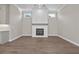 Cozy living room with wood floors, featuring a modern fireplace with a decorative mantel at 517 Godfrey Dr, Cumming, GA 30040